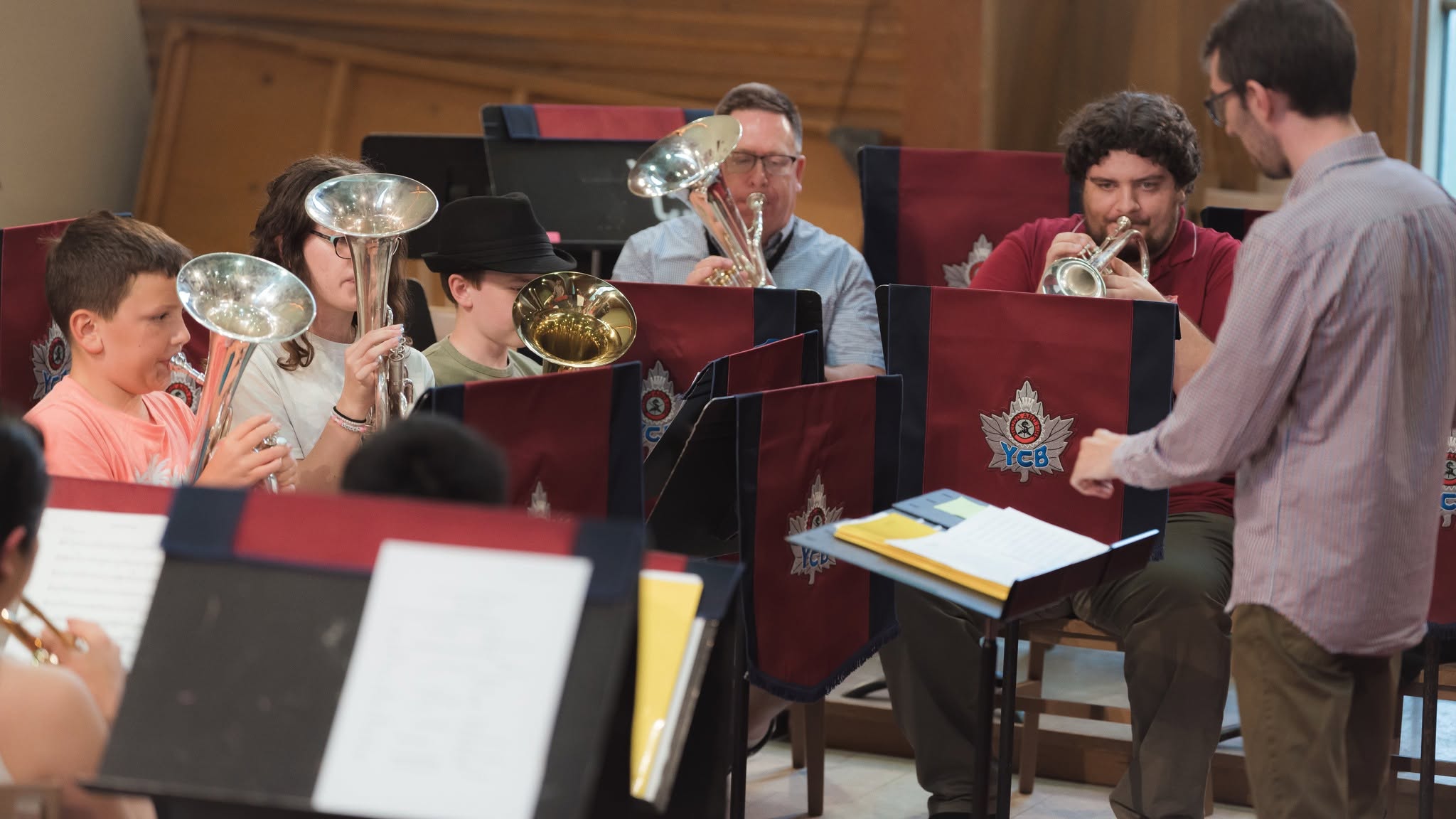 children and adults playing brass instruments